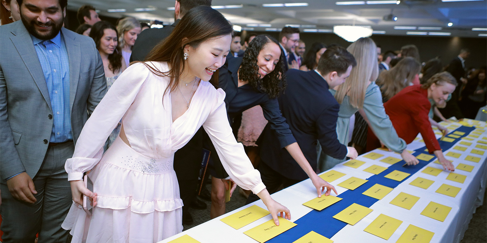 Medical student Teresa Wong reaches for her envelope, along with her fellow students, at the Match Day celebration. 
