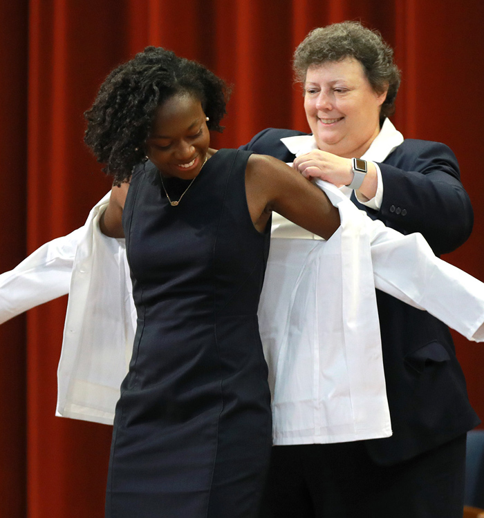 Photo of student receiving white coat