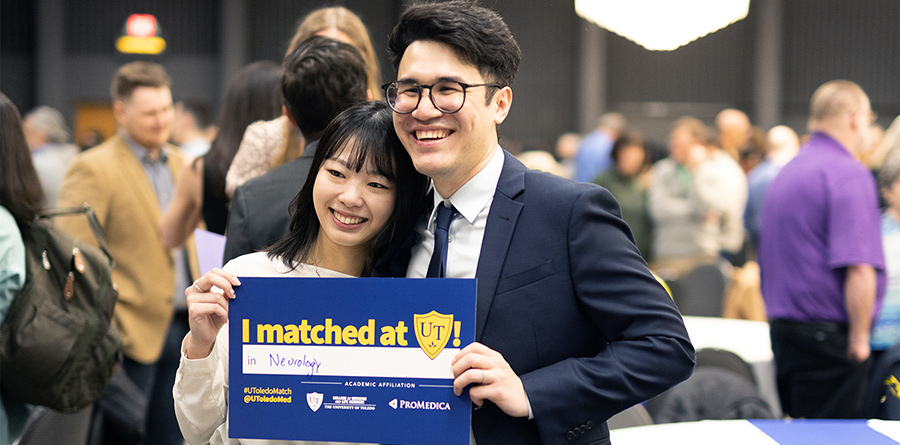 Fourth-year medical student holds sign at Match Day celebrations. 