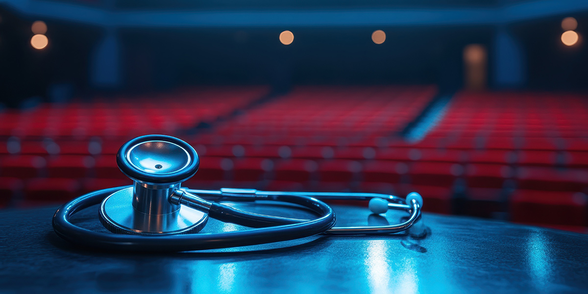 An illustrated photo of a stethoscope resting on a table in an empty theater before a medical presentation.