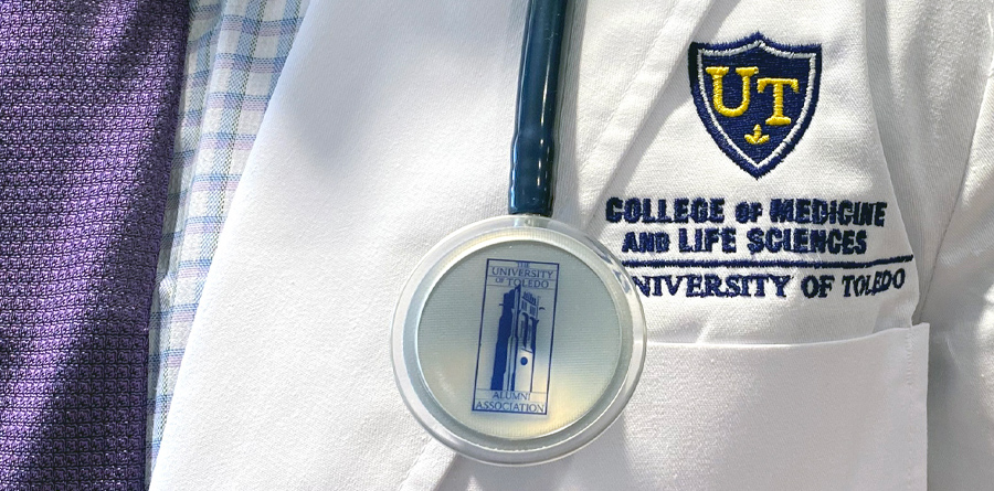 Student wearing white coat and stethoscope