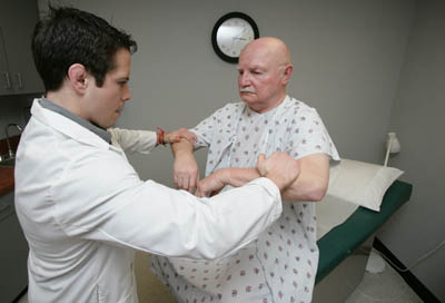 Student with patient in community care clinic