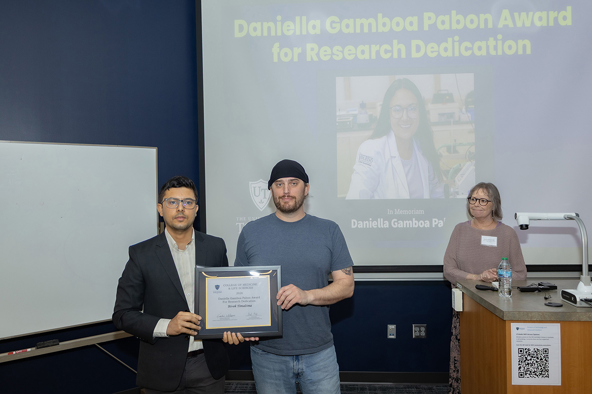 Bivek Timalsina (left) poses with a family friend of Daniella Gamboa Pabon after receiving the Award for Research Dedication at the Graduate Research Annual Forum.