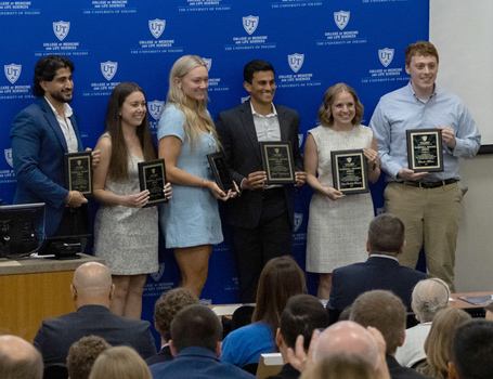 Photo of students holding their awards at the 2026 Graduation Awards