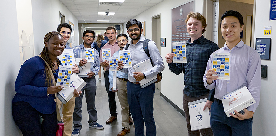 A group of new students hold up their BINGO cards during M.D. Orientation in 2022.