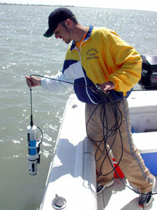 man in boat raising equipment