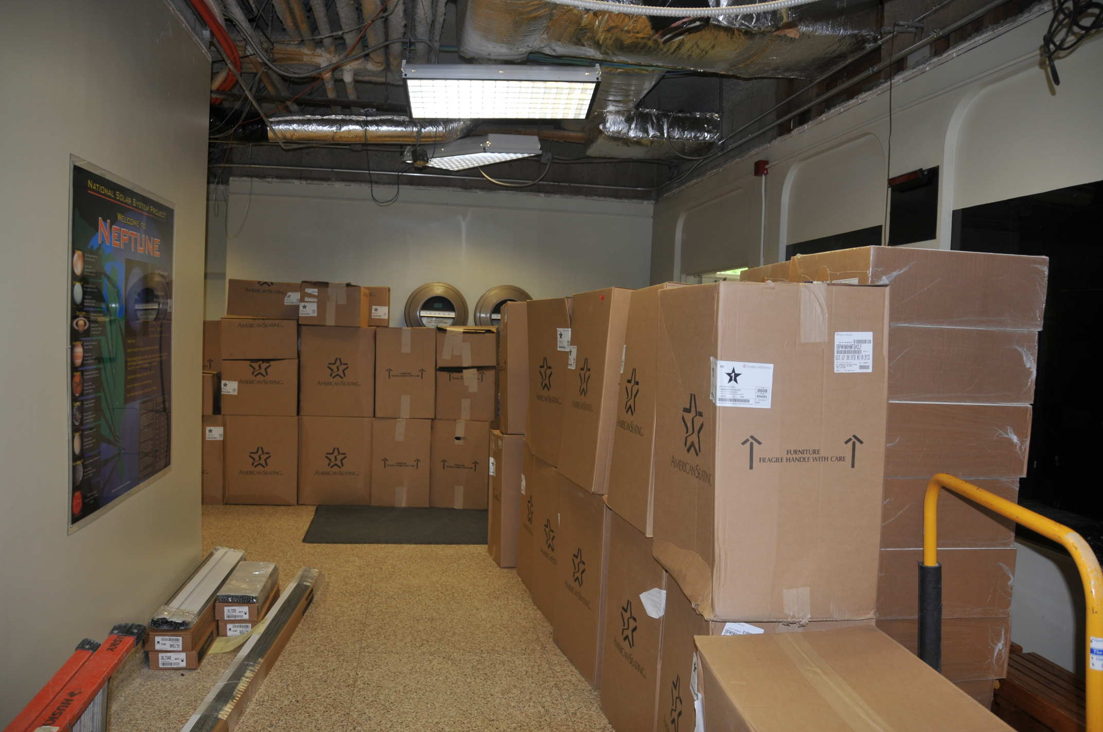 The new seats, in boxes, in the planetarium lobby.