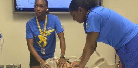 Students doing a CPR simulation on a high fidelity mannequin