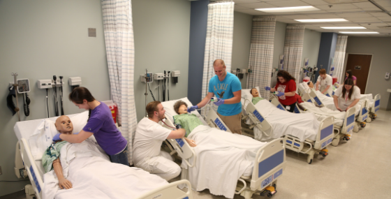 students lined up working on mannequins in lab