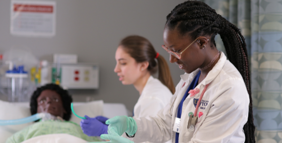 two female students practicing in lab