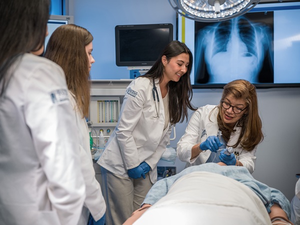 faculty teaching students in lab