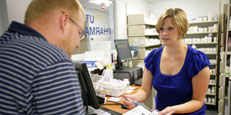 Pharmacist waiting on customer