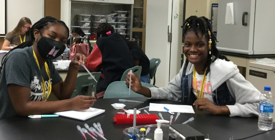 Campers using pipettes in experiment