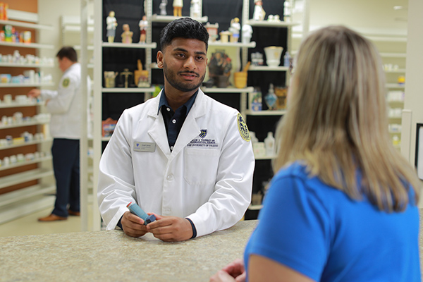 A pharmacist helping a patient at the pharmacy counter