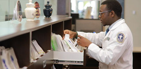 A resident working in a pharmacy