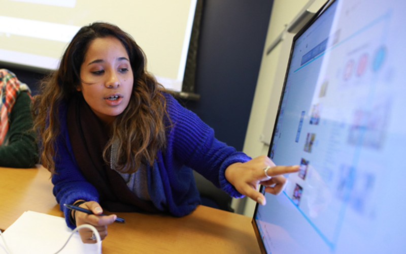 student points at image on computer screen
