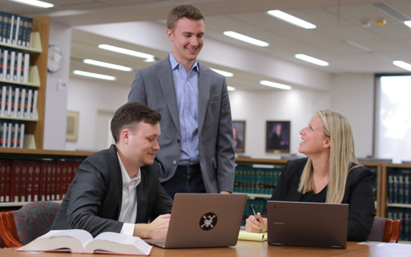 three students meet in the library 