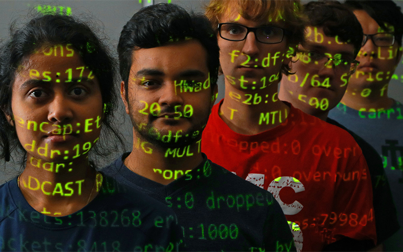 five students standing in a row with a graphic displaying code