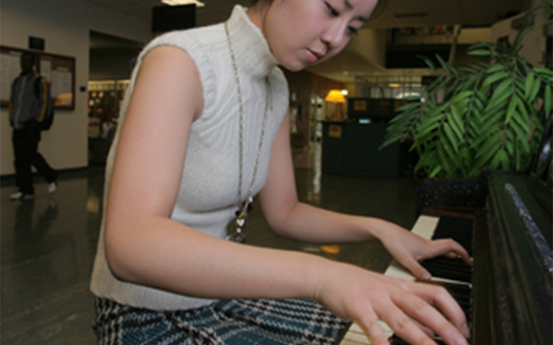 a pianist performs in a lobby