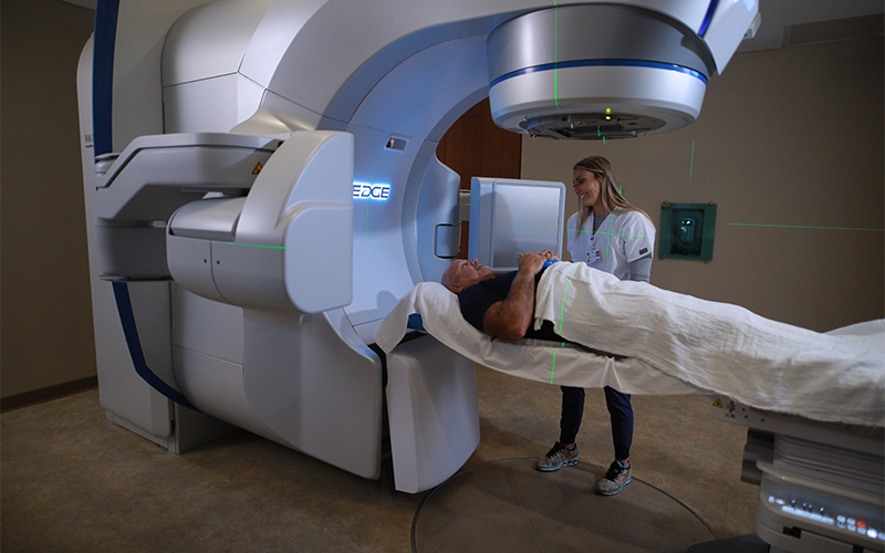 doctor takes measurements of patient laying in down on a medical scanner and imaging machine
