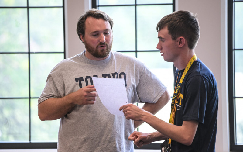 two students standing while having a conversation