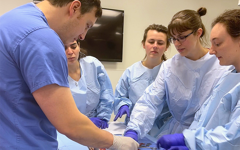 a group of medical students wearing blue scrubs