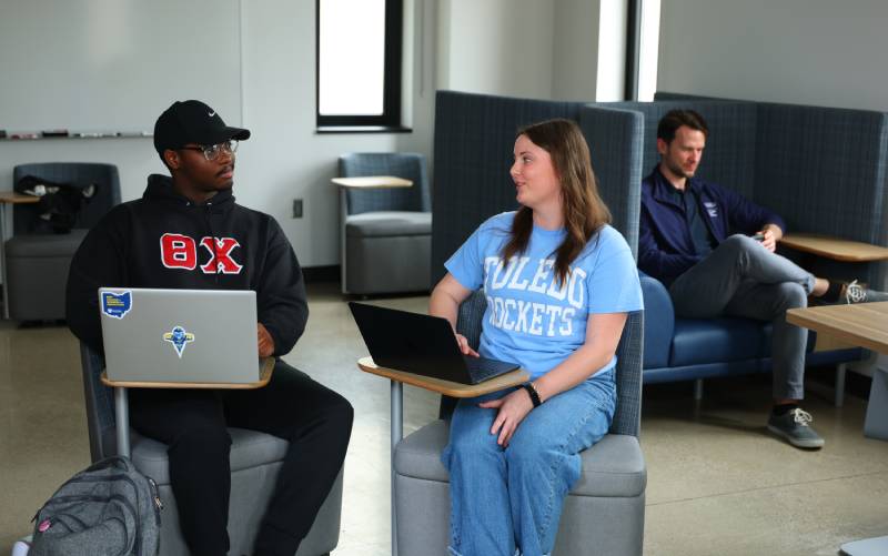 students sit side by side in desks