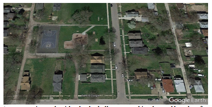 community park with a basketball court, parking lot and benches for picnics