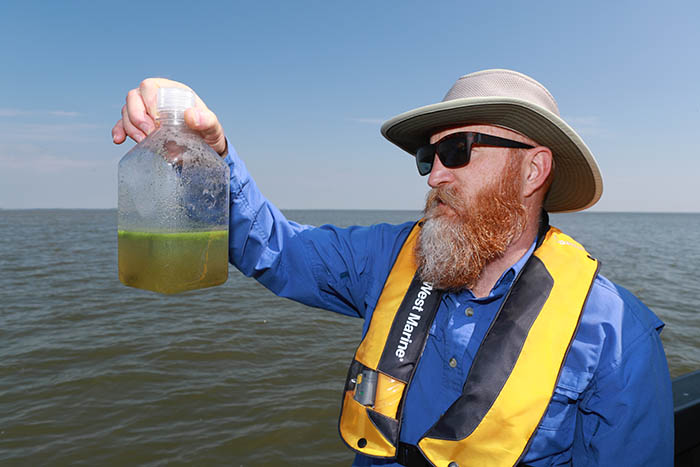 Dr. Tom Bridgeman reviewing water sample