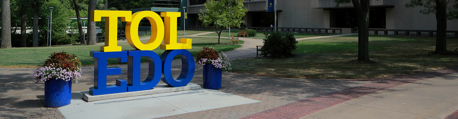 Blue and Yellow UToledo sign on campus