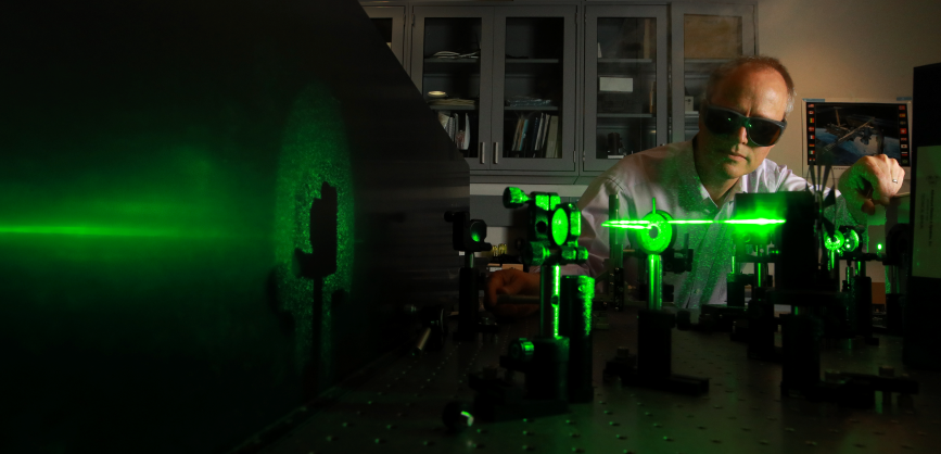 Licensable Technologies Man in Lab Goggles Using Green Laser Beam