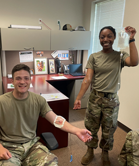 Cadet Lauryen Smith holding an IV bag of a fellow cadet