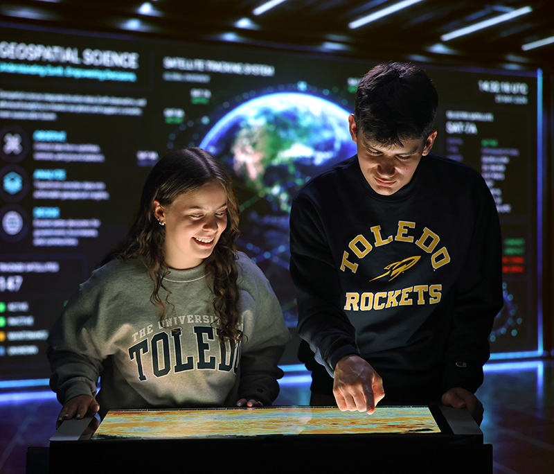 Two students reviewing data for new geography degree program