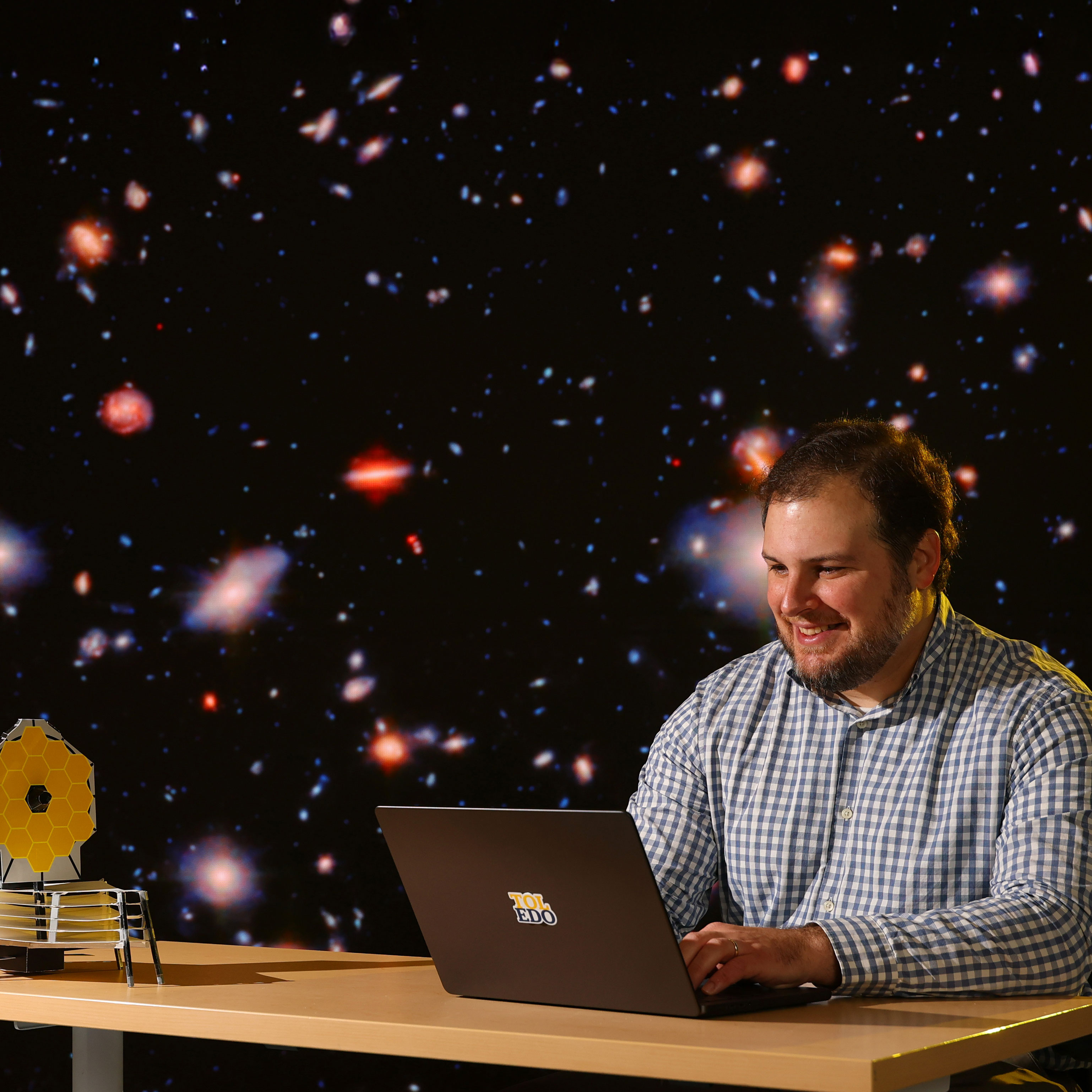 Dr. Eli Visbal on computer with stars on background
