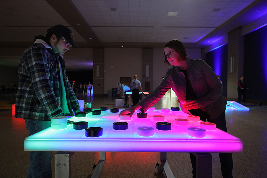 mom and son playing glow checkers