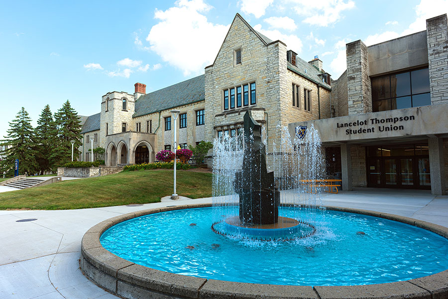 Lancelot Thompson student union exterior featuring Edison Memorial Fountain surrounded by grassy area and trees of centennial mall