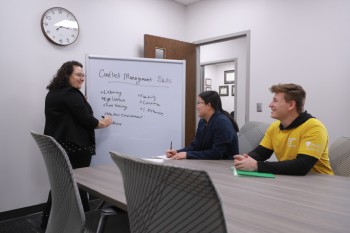 group discussion at table and whiteboard