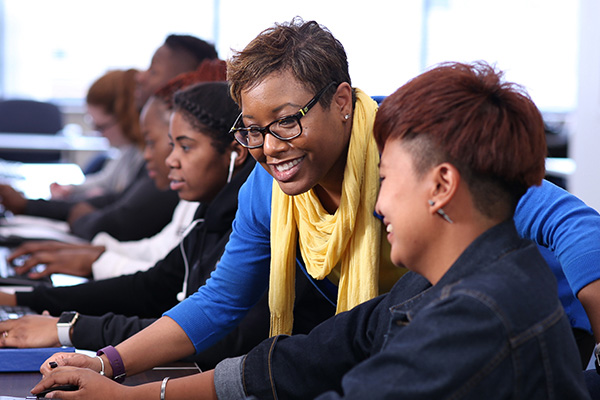 instructor helping a student on computer