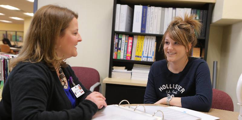 student meeting with a staff member