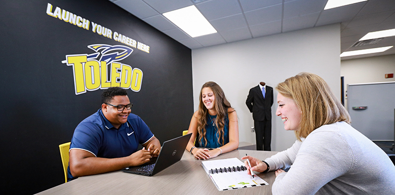 Students talking around the table at Career Services Center