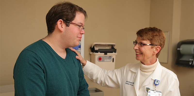 student in the medical exam room with a physician