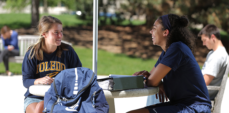 students sitting on a table at the centennial mall