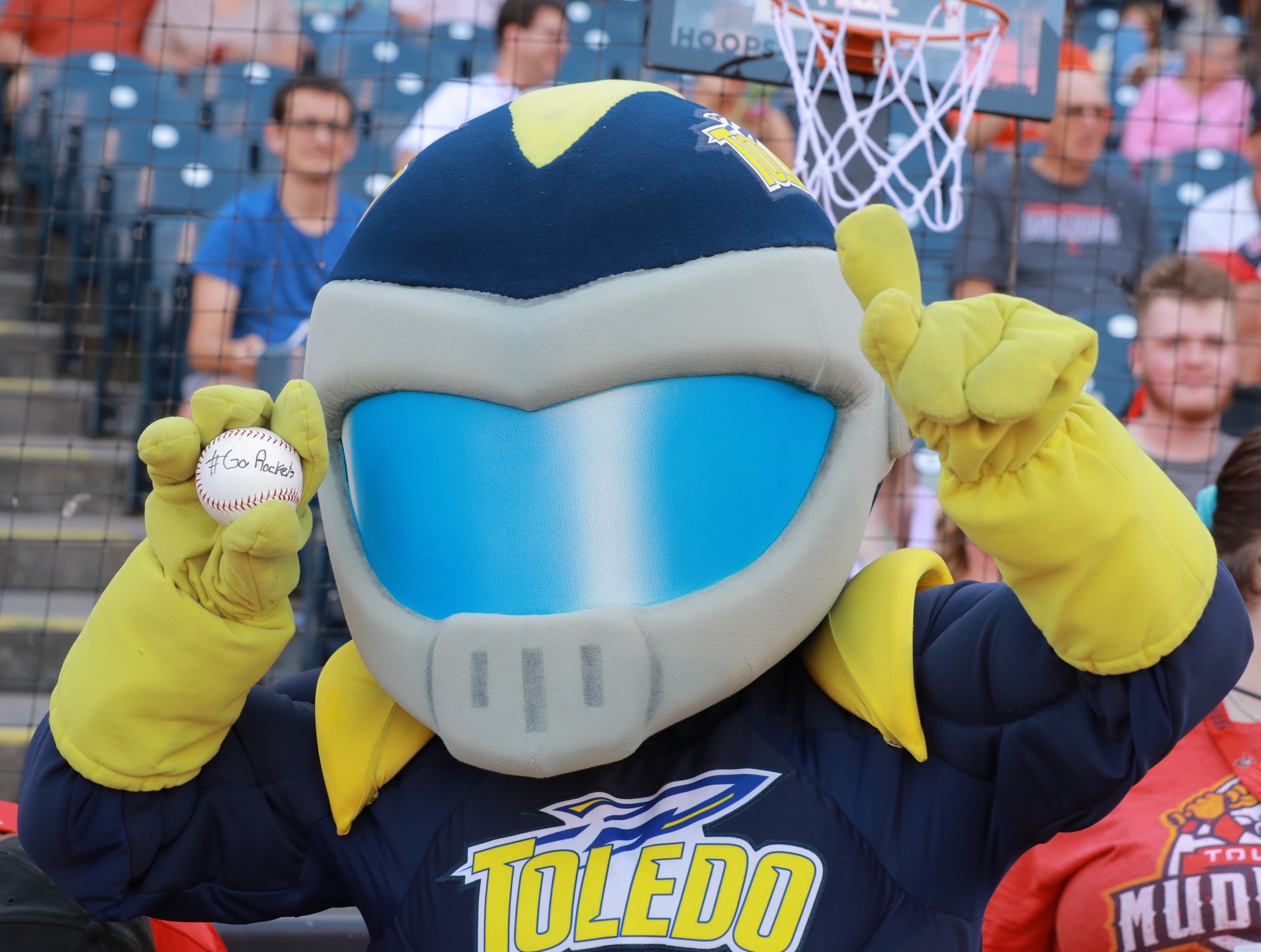 Rocky the UToledo mascot at the Mudhens stadium holding a baseball