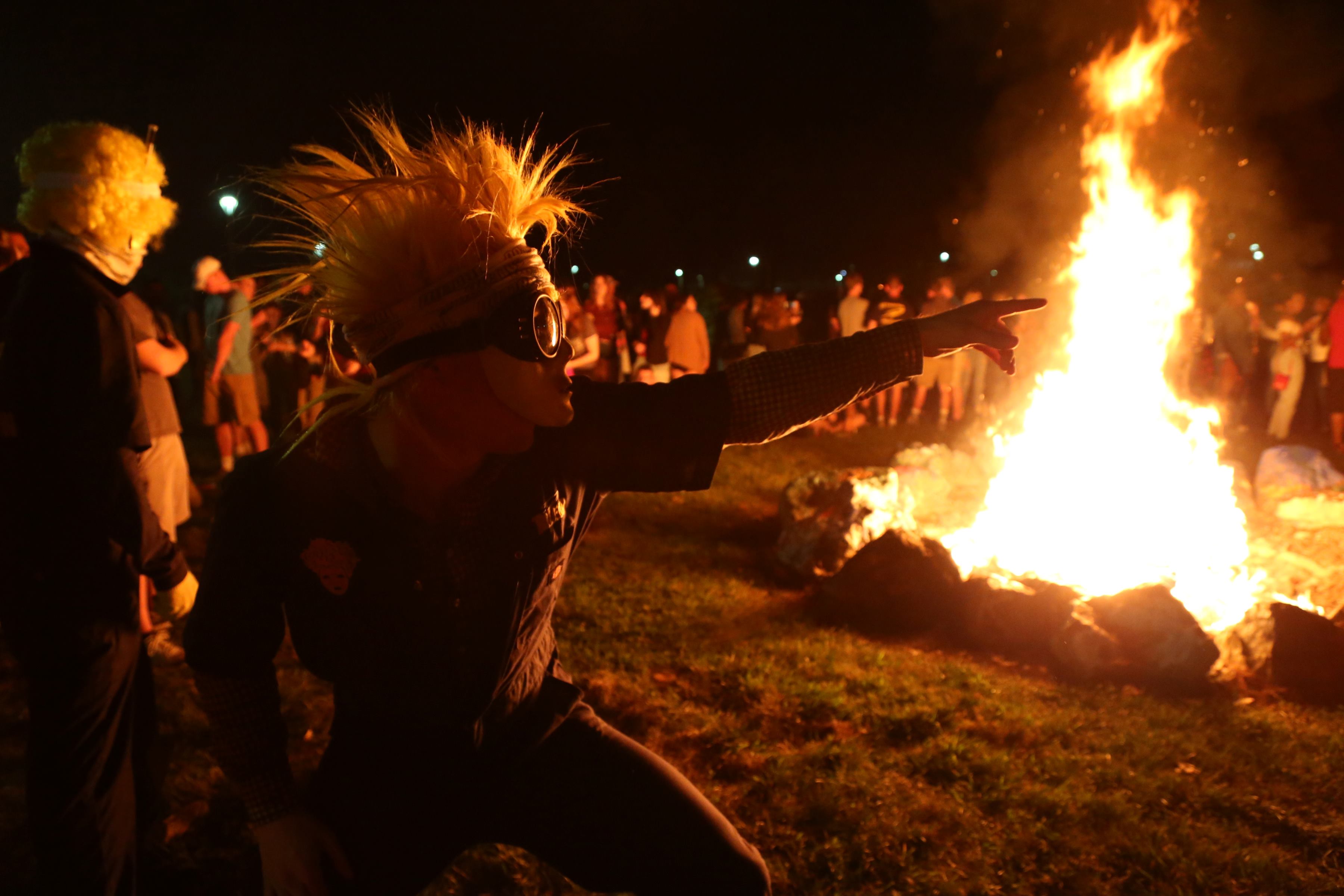members of the UToledo spirit squad "Blue Crew" in their unifrom at a bonfire in the Flatlands