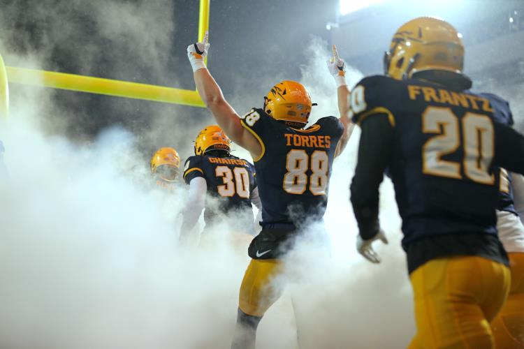 UToledo football players entering the stadium. 