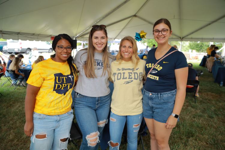 four female students standing together at the tailgate. 