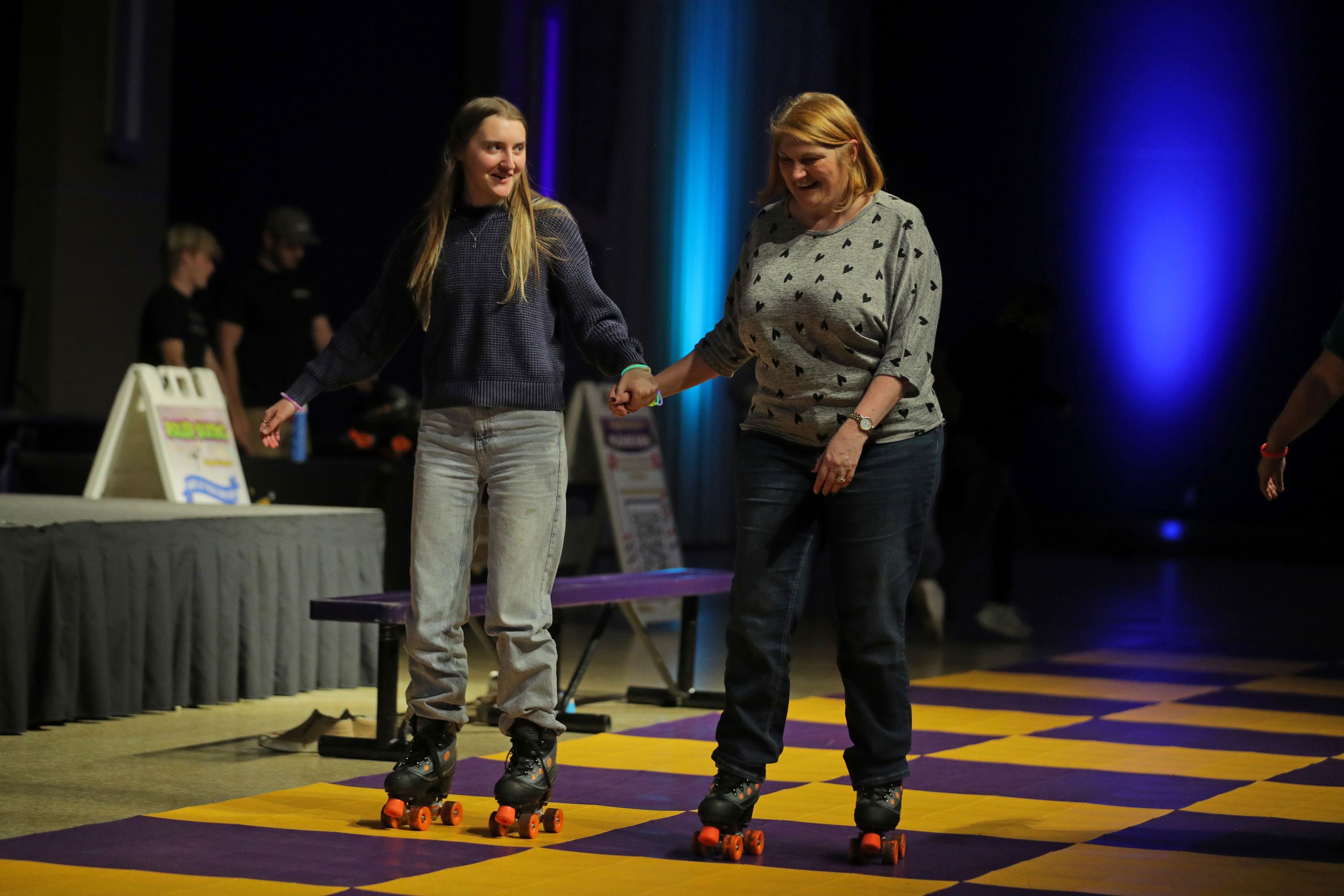 a mother and daughter skating during Mom's Weekend glow party