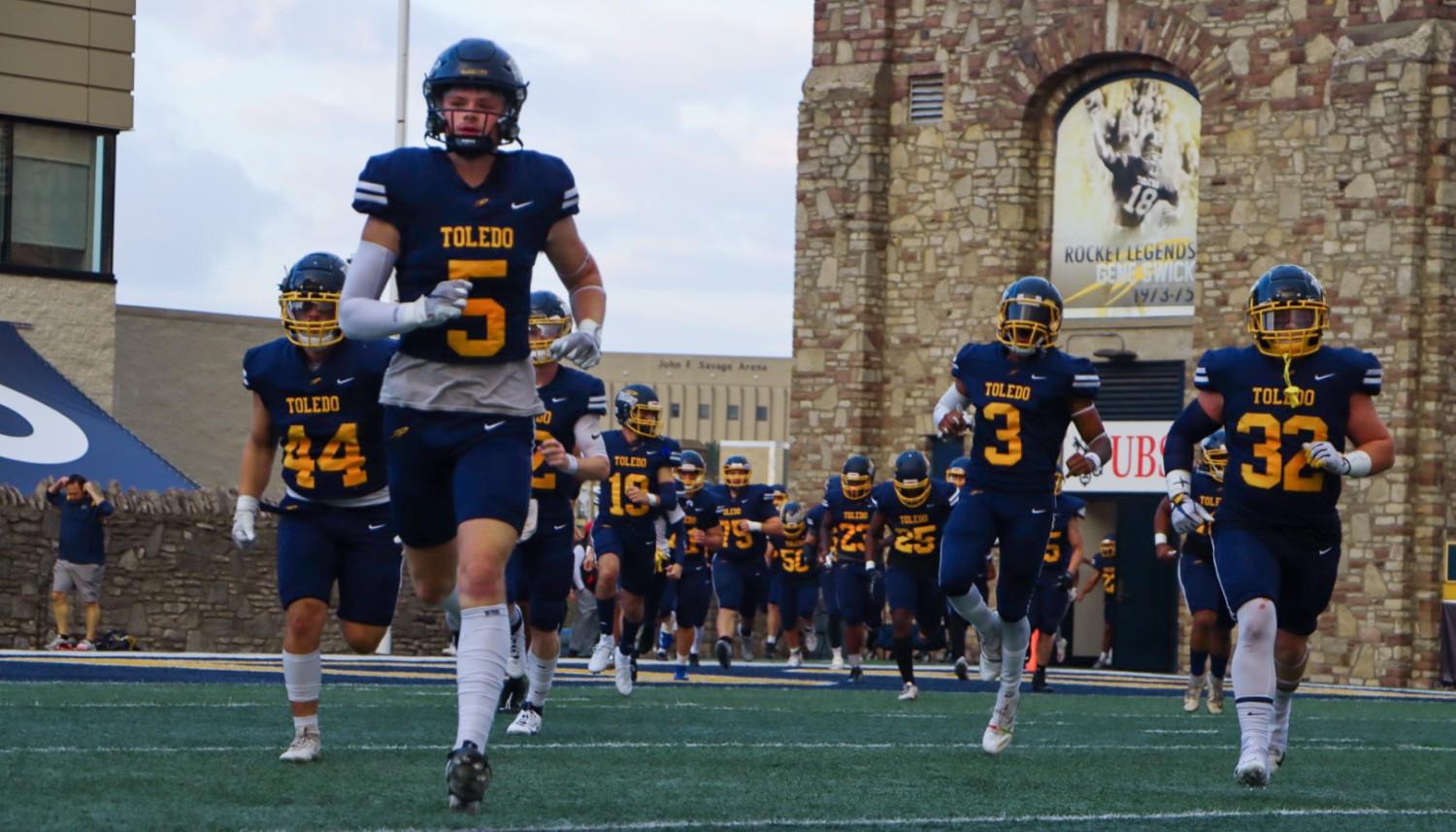 UToledo Football Team running onto the Glass Bowl stadium field
