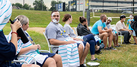 group of kids camp parents lounging in lawn chairs