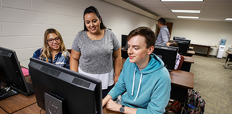 Students sitting at a computer